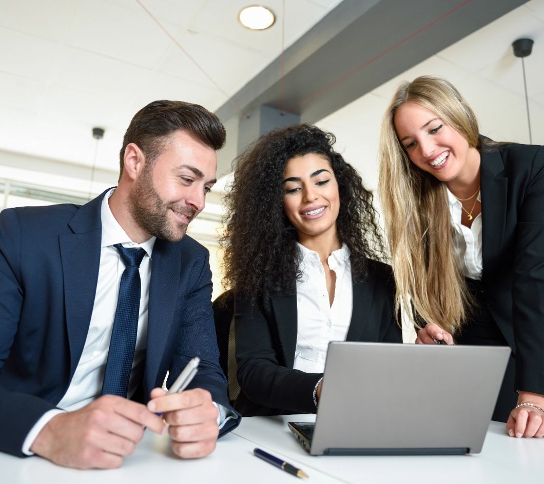 multi-ethnic-group-three-businesspeople-meeting-modern-office-two-women-man-wearing-suit-looking-laptop-computer@2x.jpg